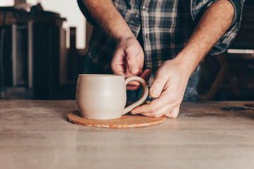 Potter works on a ceramic cup