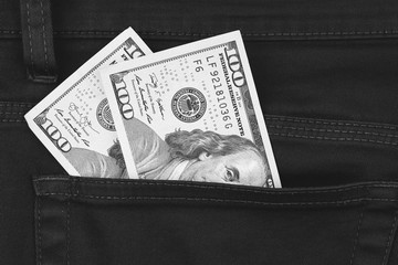 One hundred dollar banknote money in pocket trouser pants background texture. dollar bill close up