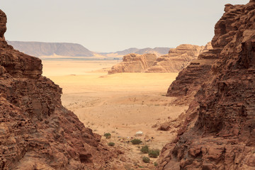 Wadi Rum desert panorama seen from canyon with dunes, mountains and sand, Jordan