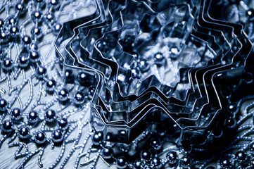 Metal molds for biscuits of various shapes on a gray background with New Year's garland