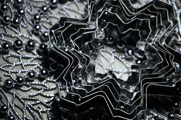 Metal molds for biscuits of various shapes on a gray background with New Year's garland