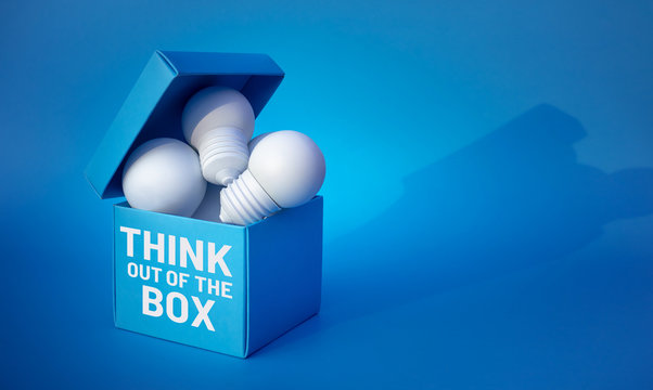 Think out of the box concepts with lightbulb. in box