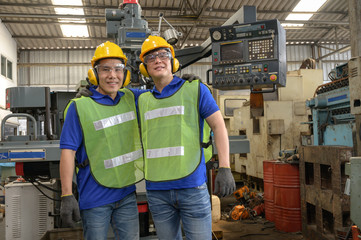 Two Male asian inspector, engineer embrance  in the production line process in factory