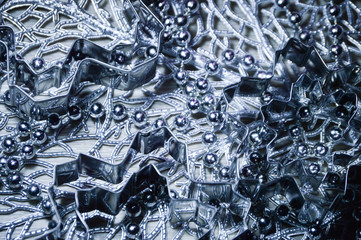 Metal molds for biscuits of various shapes on a gray background with New Year's garland