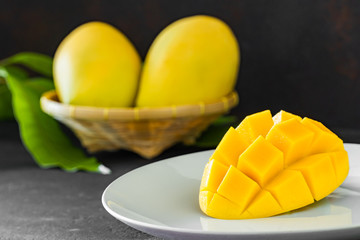 Ripe mango slice on white plate
