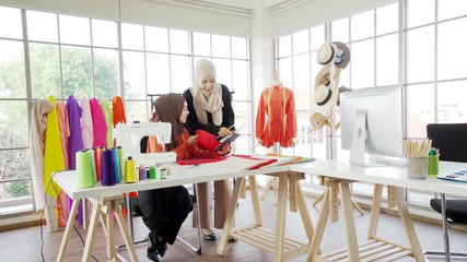 Two Asian Muslim girls Currently working on designing a design within the office.