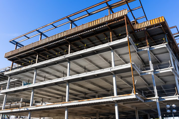 Detail of multilevel modern office building under construction with visible steel frame, Silicon Valley, California