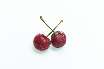 group of frozen cherries on a white background . ice crystals on the berry. vertical photo.