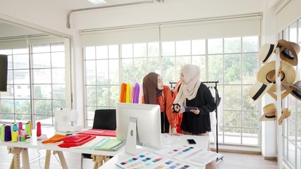 Two Asian Muslim girls Currently working on designing a design within the office.