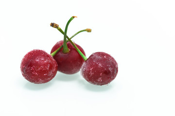 group of frozen cherries on a white background . ice crystals on the berry. vertical photo.