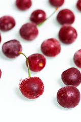 frozen cherry on a white background . ice crystals on the berry. vertical photo.