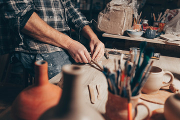 Process of creating a clay cup in pottery workshop