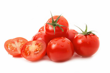 Fresh tomatoes - one sliced - isolated against white