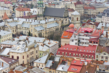 Fototapeta na wymiar The view from the heights of the rooftops of an old European city. Background for urban architecture. Europe.