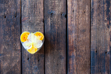 Yellow and white flowers roses in the shape of a heart. Wrapped Gift. Love