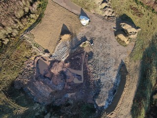An aerial view of a small quarry looking straight down from above