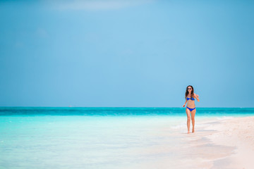 Young fashion woman in green dress on the beach