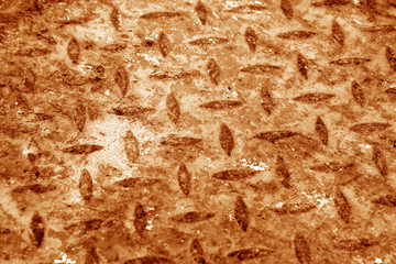Grungy rust metal dimond floor with blur effect in orange tone.