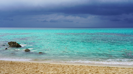 Incredible bright blue turquoise water of the Pacific Ocean off the coast of a tropical island. stormy sky over bright clear sea water