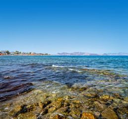 Landscape with beach and islands in horizon on sunny day