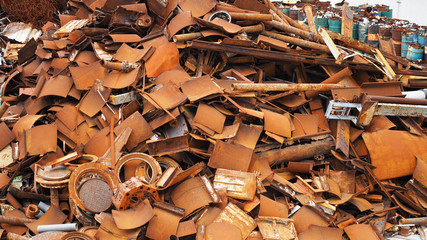 Texture of a metal dump. various forms of rusty metal construction. destroyed metal products on a...