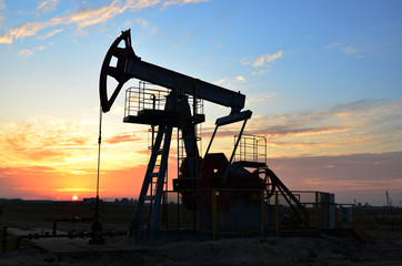 Oil drilling derricks at desert oilfield for fossil fuels output and crude oil production from the...