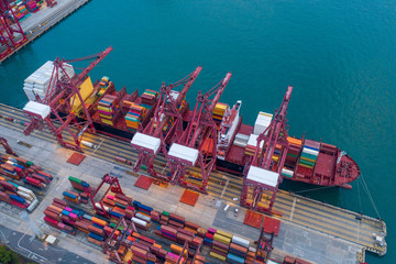 Container terminal, cranes loaded containers on a ships board, view from above