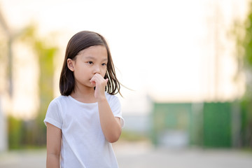 Thoughtful worried young girl looking away thinking of loneliness expressed through facial with...