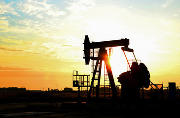 Oil drilling derricks at desert oilfield for fossil fuels output and crude oil production from the...