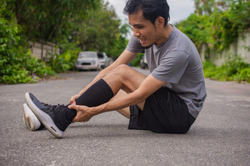 Runner man knee pain at running on street