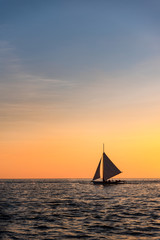 Obraz na płótnie Canvas Paraw sailing at Boracay Island, Philippines at Sunset
