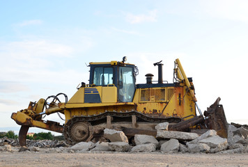 Track-type bulldozer, earth-moving equipment. Land clearing, grading, pool excavation, utility trenching, utility trenching and foundation digging during of large construction jobs. © MaxSafaniuk