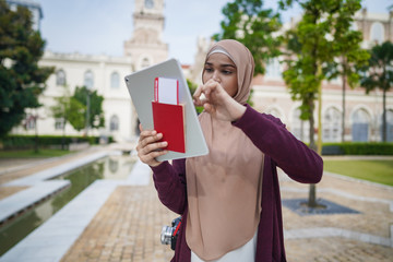 Portrait of beautiful young solo Muslim traveler exploring the city