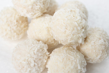 Sweets with almonds and coconut closeup on a white background
