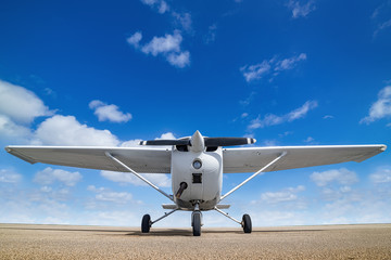 white sports plane againstr a perfect blue sky