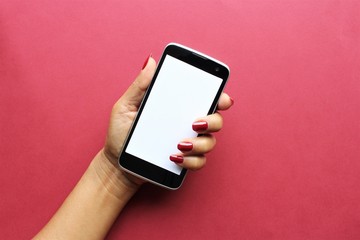 Woman hand red fingernail showing black smartphone empty white screen photo isolate on pink background copy space