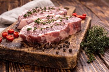 pork meat on wooden background.