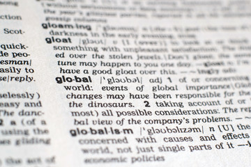 Fototapeta premium A close-up on a word Global in English dictionary (selective focus)