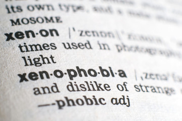 Fototapeta premium A close-up on a word Xenophobia in English dictionary (selective focus)
