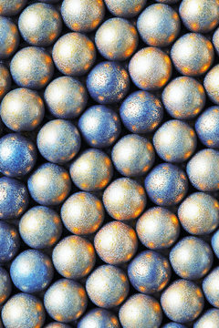 The surface of the many balls of light yellow and blue. Abstract bright festive background or wallpaper. View from above. Vertical shot. Macro
