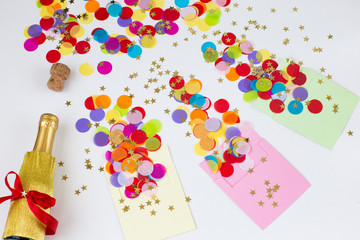 Three envelopes on a white background, colored confetti are flying from them, a bottle of champagne is next to it 