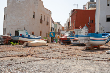 Small fishing boats pulled ashore on the beach in the island of Marettimo, in the Egadi islands in Sicily, Italy.