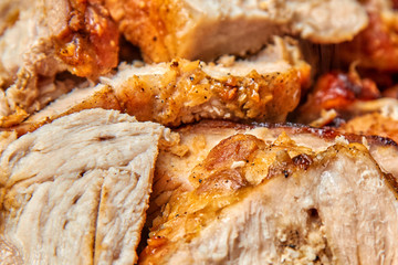baked meat cut into pieces close up photo