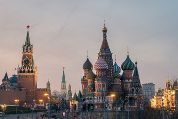 Spasskaya tower with watch of Moscow Kremlin architectural ensemble and Saint Basil's Cathedral at...