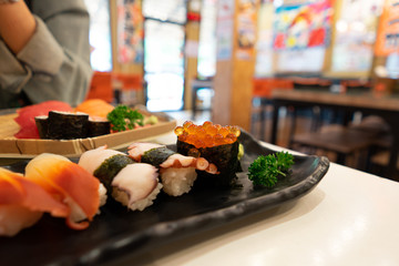 Sushi and Sushi Roll Many many kinds on the table. Focus on salmon roe