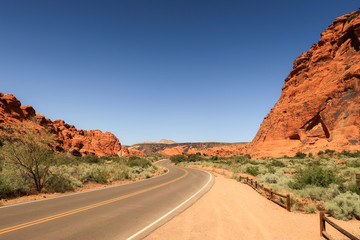 Fototapeta na wymiar Landscape of a road in the red hills of Snow Canyon State Park in Utah