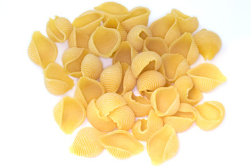 Heap of conchiglie pasta on white background