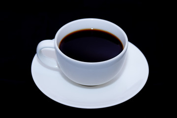 White cup of coffee on black background