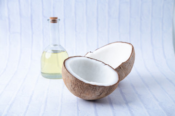 coconuts and Coconut oil product organic for cosmetic natural care health in a bottle put on a white table,  Concept: alternative aromatherapy aromatic ingredient vitamin for therapy and massage spa