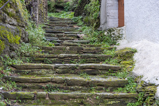 Greece, Tzia Kea island. Ioulis city narrow street with stairs and traditional stone walls